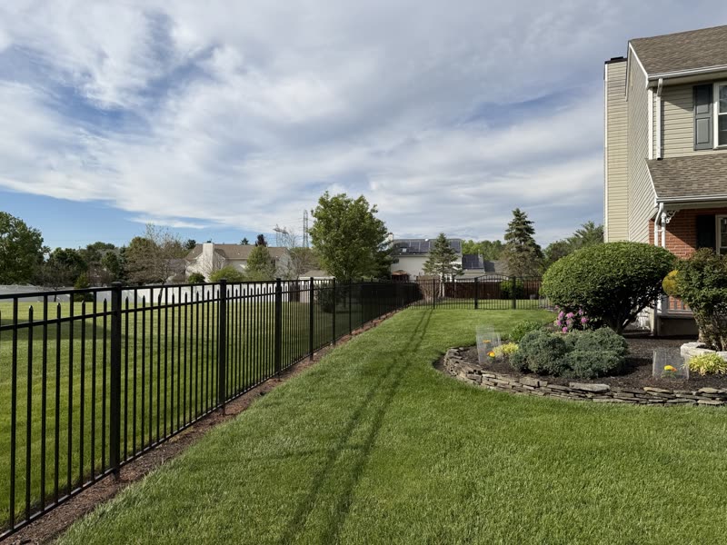 Black aluminum fence along garden beds