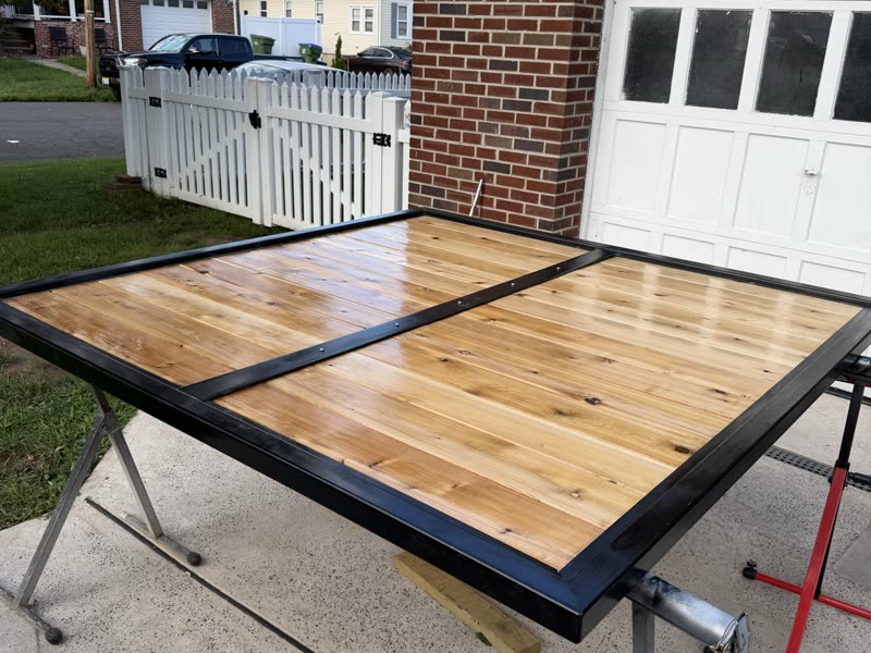 Cedar gate panel in a black steel frame on the workbench