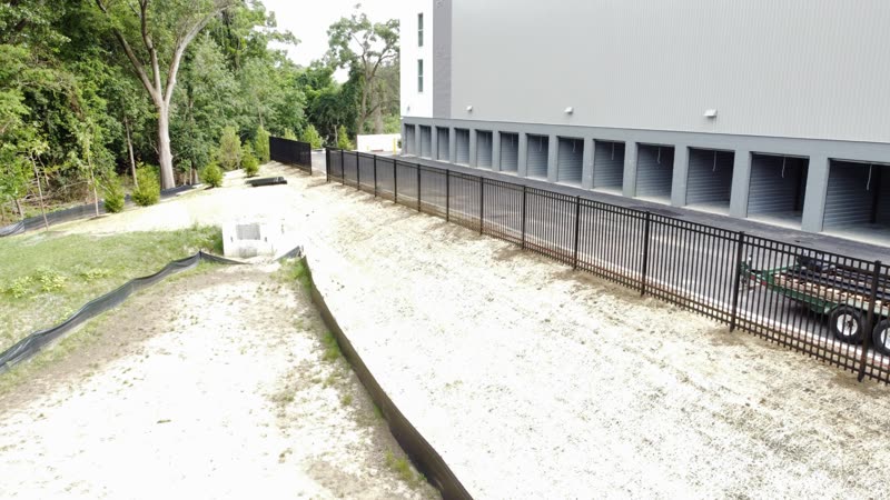 Black aluminum fence along a self-storage building