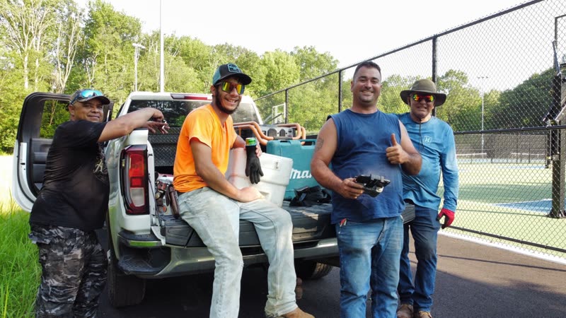 The Elite Fencing crew beside their truck