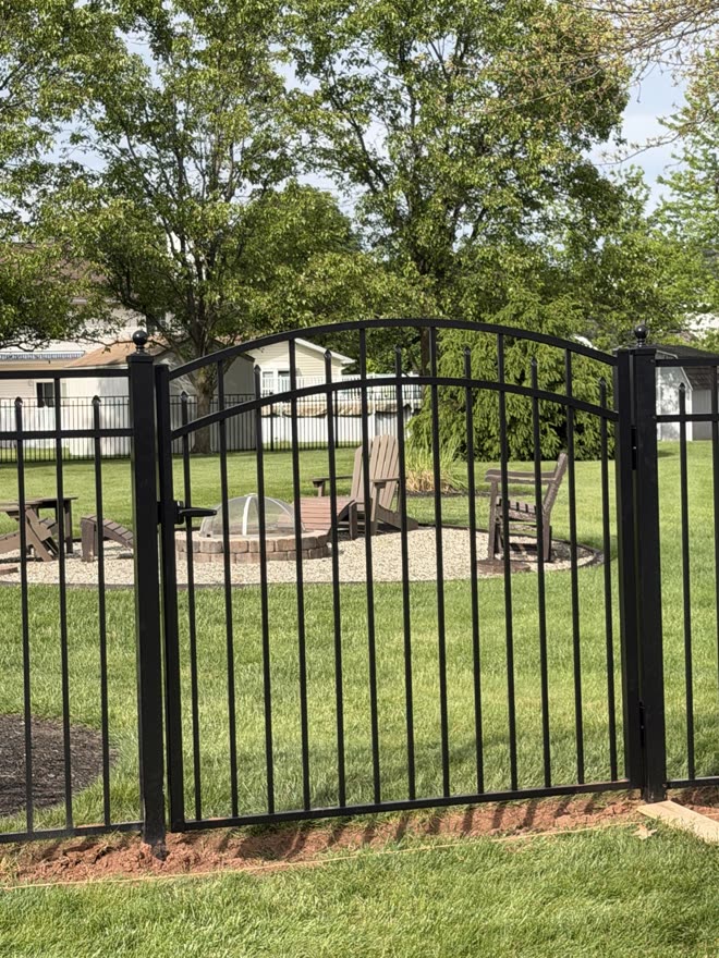 Arched black aluminum walk gate, close up