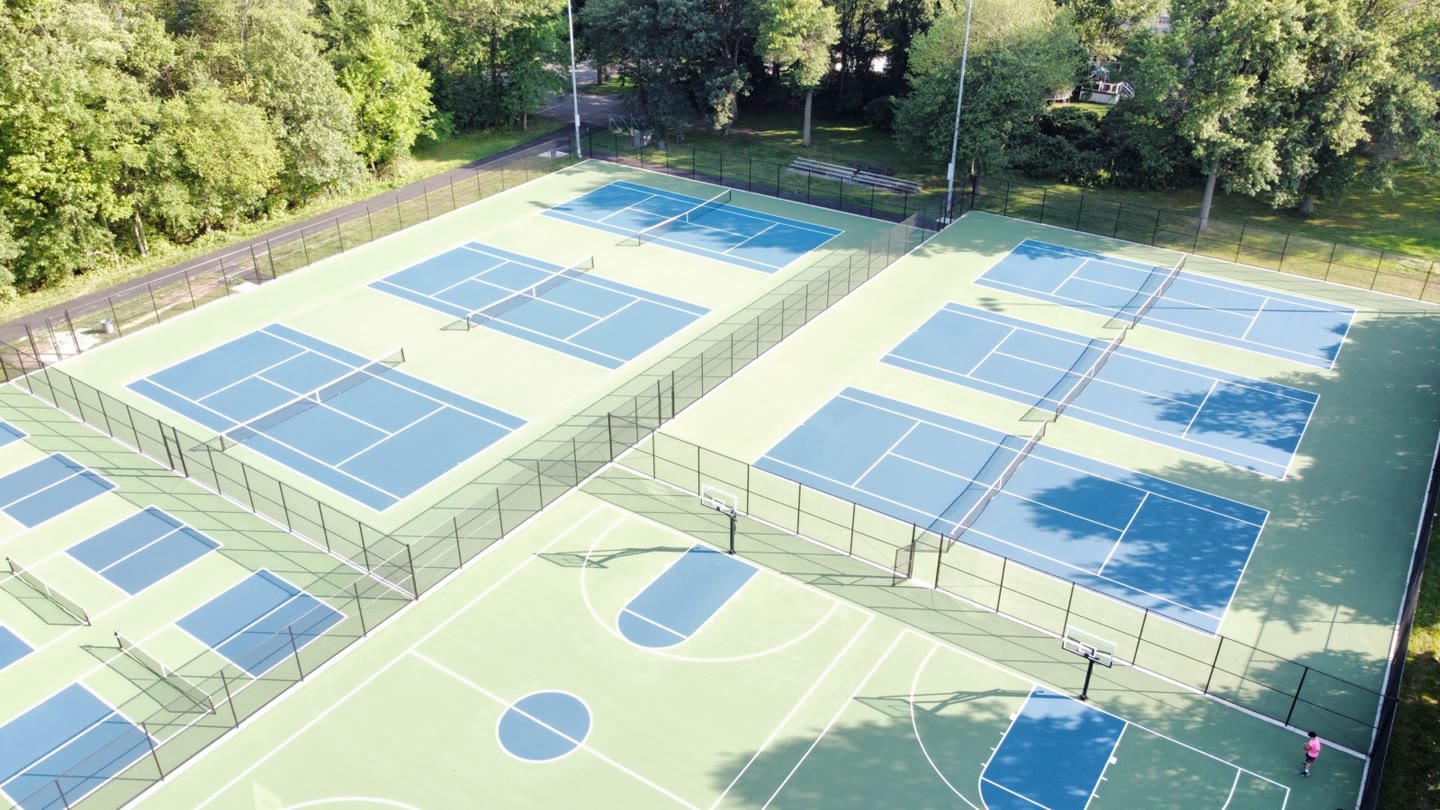 Aerial view of black chain link fencing around tennis and basketball courts